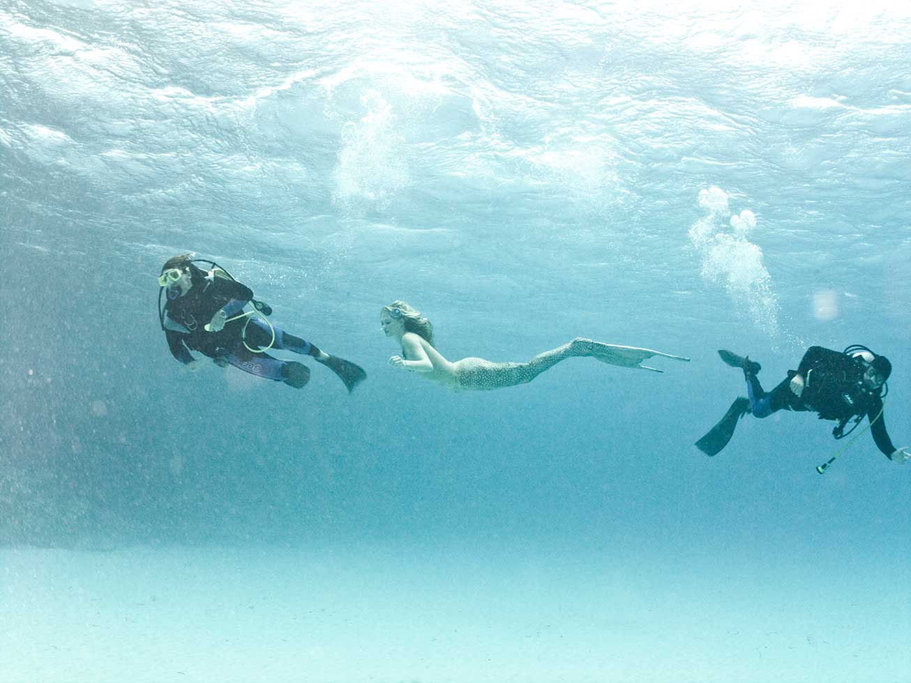 So thats how they do it! Divers swim rapidly out of shot to clear frame before the photographer snaps the picture whilst the mermaid hangs gracefully in the ocean tied to a breeze block with fishing line.