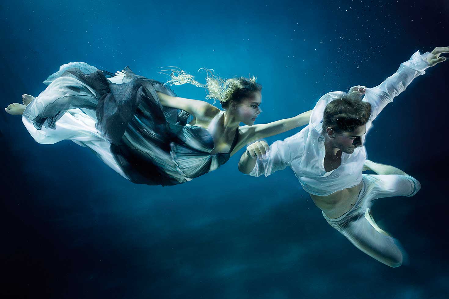 Truly, Madly, Deeply. Siren and Sailor drift in Haute Couture beneath the blue water and amongst shipwrecks. Styled by Damian Foxe. Copyright 2016 - Zena Holloway